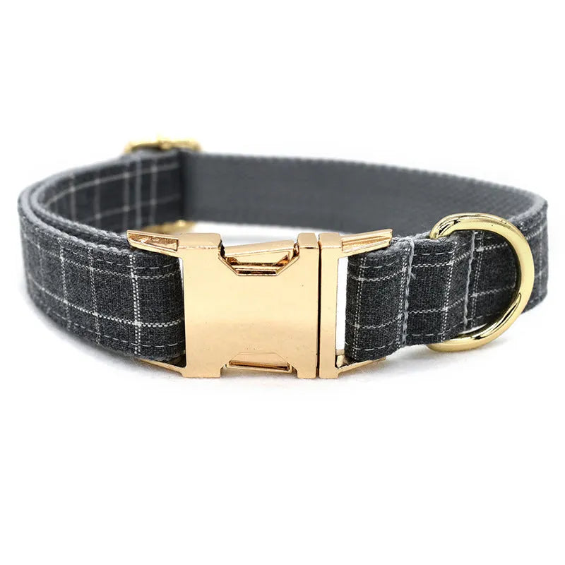 Grey plaid nylon dog collar with golden metal button on a white background, size M shown