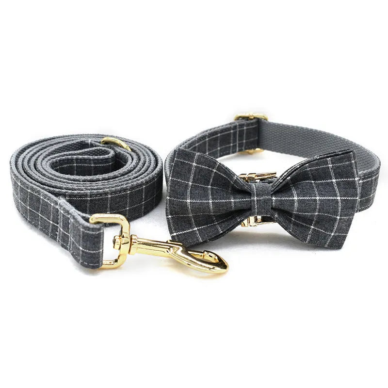 Grey plaid nylon dog collar with golden metal button on a white background, size M shown