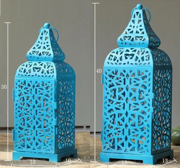 Blue geometric iron candlestick holder with hollow design, 38cm tall on wooden table
