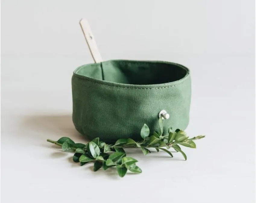 Folding canvas dog bowl in green, grey, and yellow, 15cm diameter, for portable pet feeding