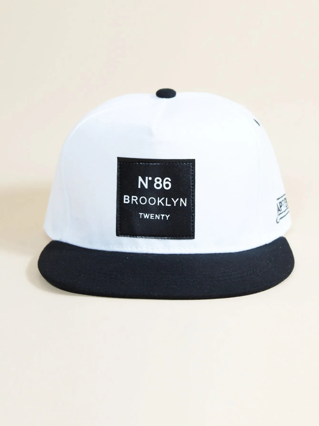Adjustable unisex baseball cap with letter design, shown in all black, black, camouflage and white