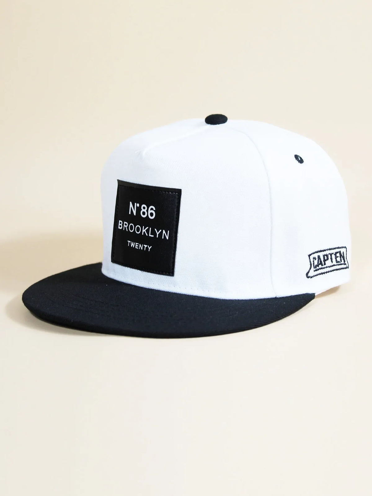 Adjustable unisex baseball cap with letter design, shown in all black, black, camouflage and white