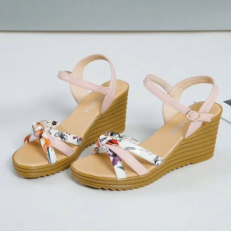 Women's pink wedge sandals with a thick 5cm heel, fish-mouth open toe, and a single adjustable buckle strap.