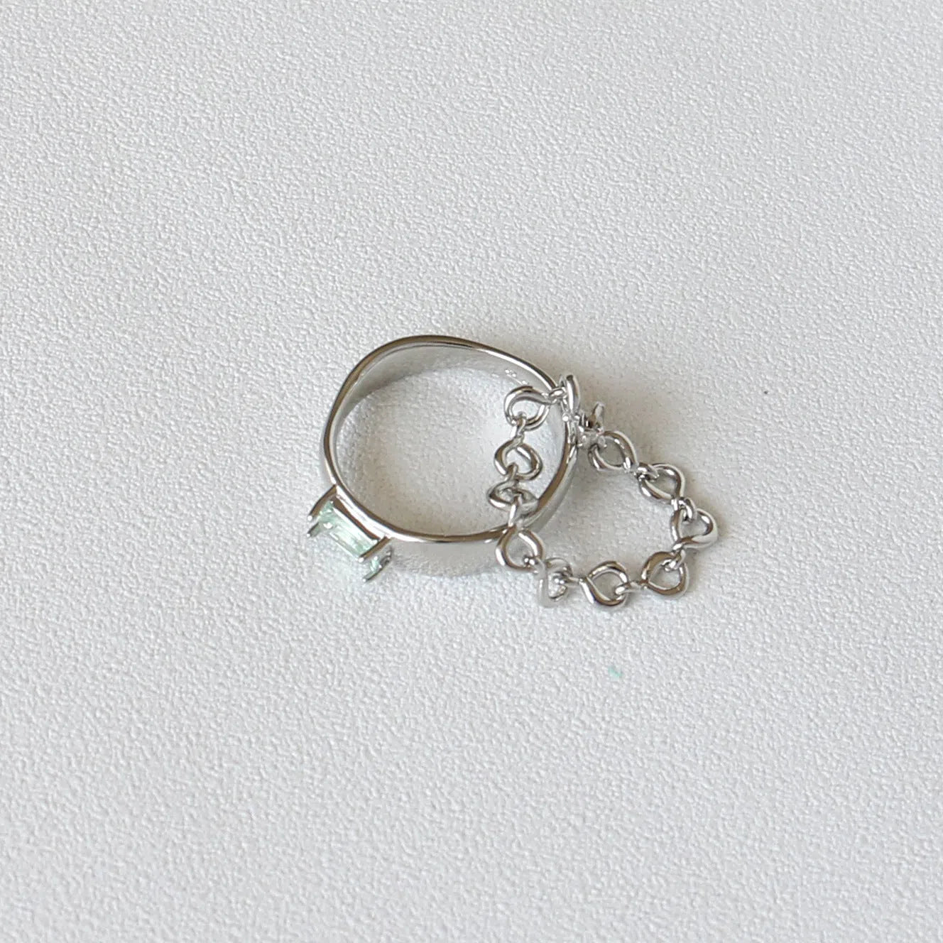 Copper platinum plated couple ring with three-ring gem design in style A on a neutral background