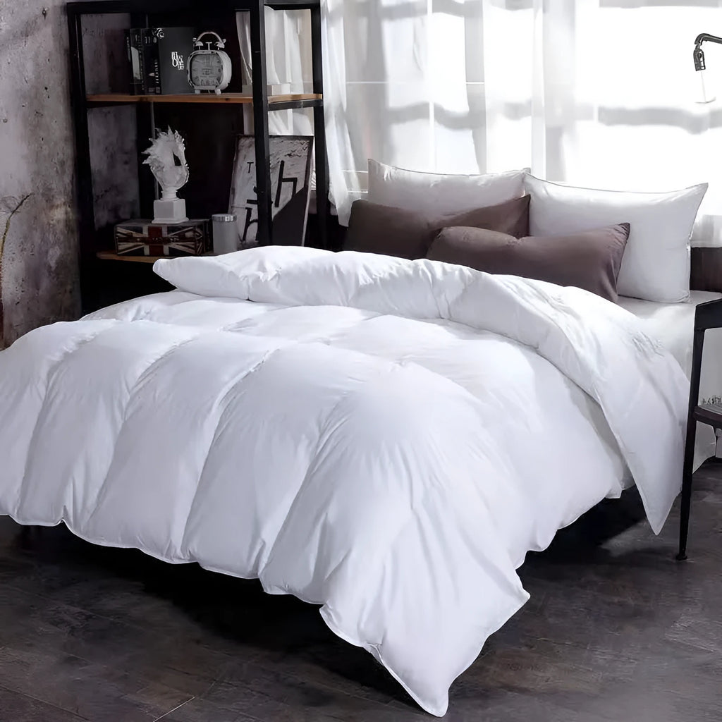 Goose down winter duvet with twill fabric cover, shown in a grey colour on a bed.