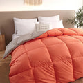 Goose down winter duvet with twill fabric cover, shown in a grey colour on a bed.