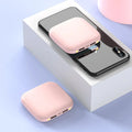 Mini black plastic power bank with an LED flashlight, showing scale against a hand.