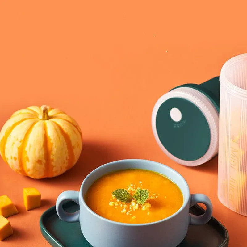 Portable electric juicer cup in pink or green with USB charging cable and pulp residue box.