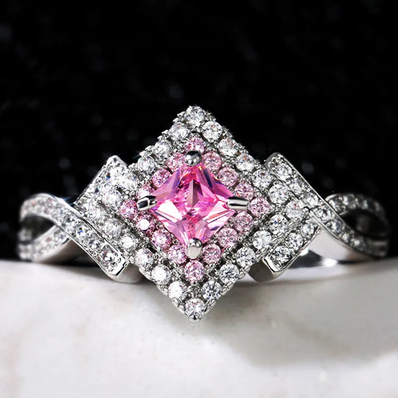 Cross-wound pink zircon ring in copper alloy with geometric modelling, ladies' simple style, sizes 6 to 10.