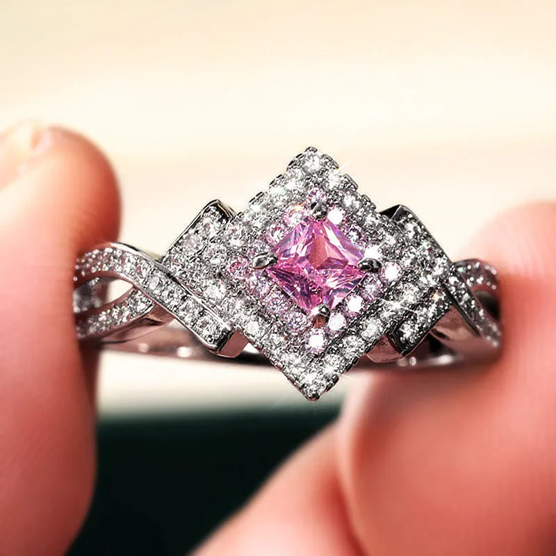 Cross-wound pink zircon ring in copper alloy with geometric modelling, ladies' simple style, sizes 6 to 10.