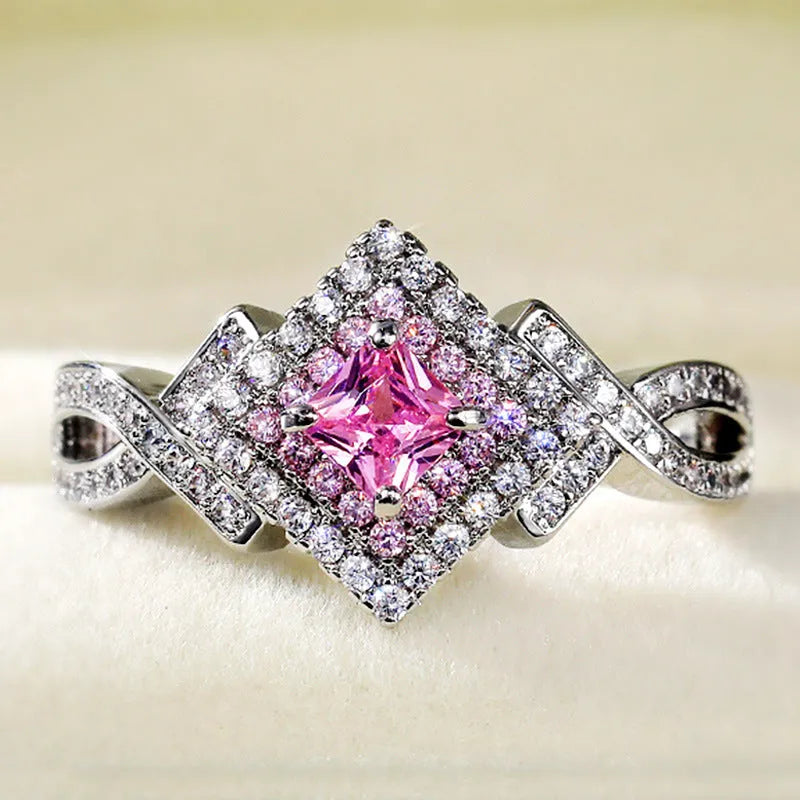 Cross-wound pink zircon ring in copper alloy with geometric modelling, ladies' simple style, sizes 6 to 10.