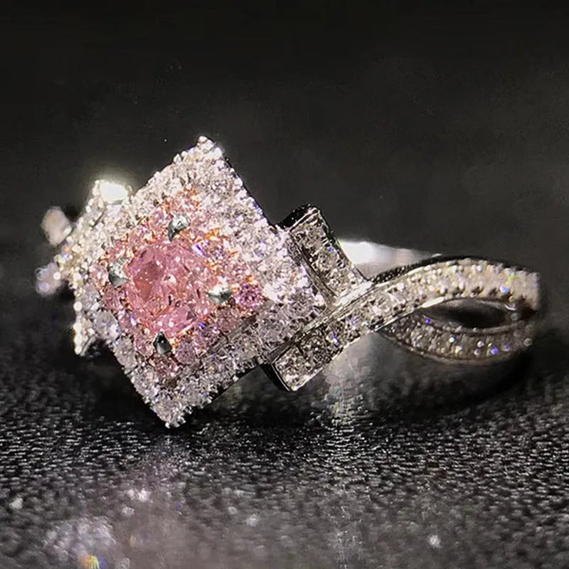Cross-wound pink zircon ring in copper alloy with geometric modelling, ladies' simple style, sizes 6 to 10.