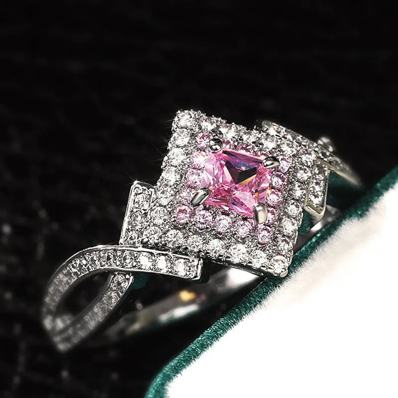 Cross-wound pink zircon ring in copper alloy with geometric modelling, ladies' simple style, sizes 6 to 10.