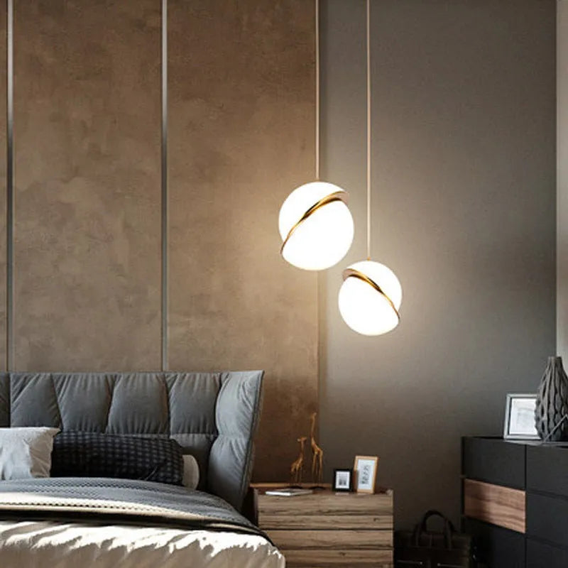 Nordic pendant light with white spherical shade hanging on adjustable cord