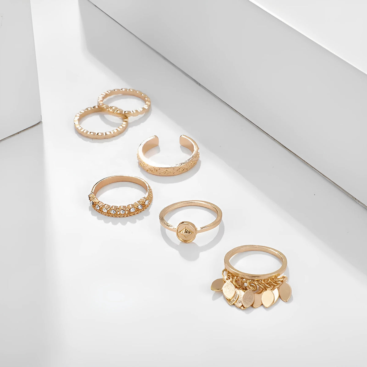 Six-piece golden alloy ring set with geometric leaf tassel design and electroplated finish