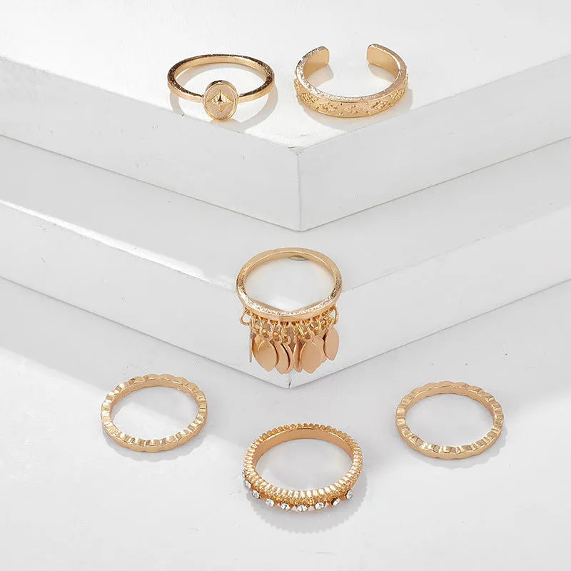 Six-piece golden alloy ring set with geometric leaf tassel design and electroplated finish