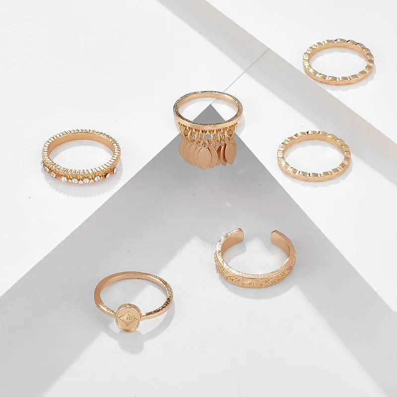 Six-piece golden alloy ring set with geometric leaf tassel design and electroplated finish