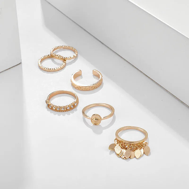 Six-piece golden alloy ring set with geometric leaf tassel design and electroplated finish