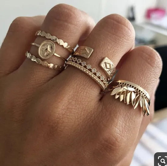 Six-piece golden alloy ring set with geometric leaf tassel design and electroplated finish