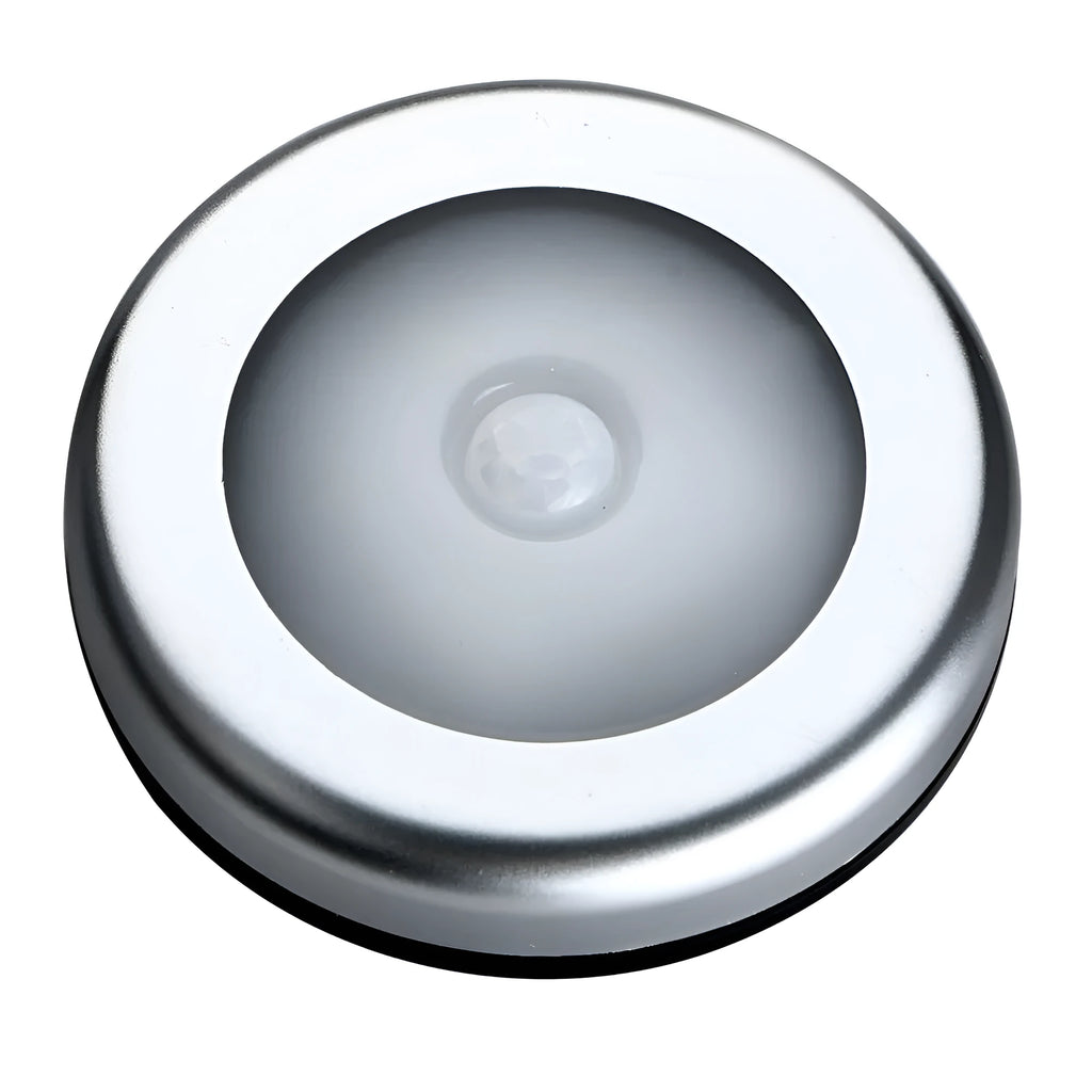 Silver coloured circular wireless motion sensor night light on a wall.