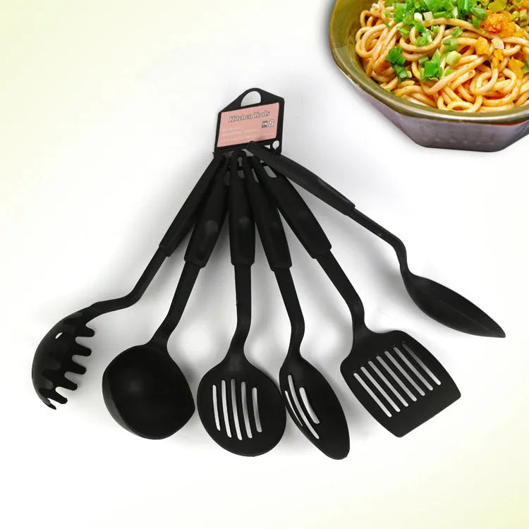Black rubber kitchen utensil set showing a solid spoon and a slotted spoon for non-stick pans.