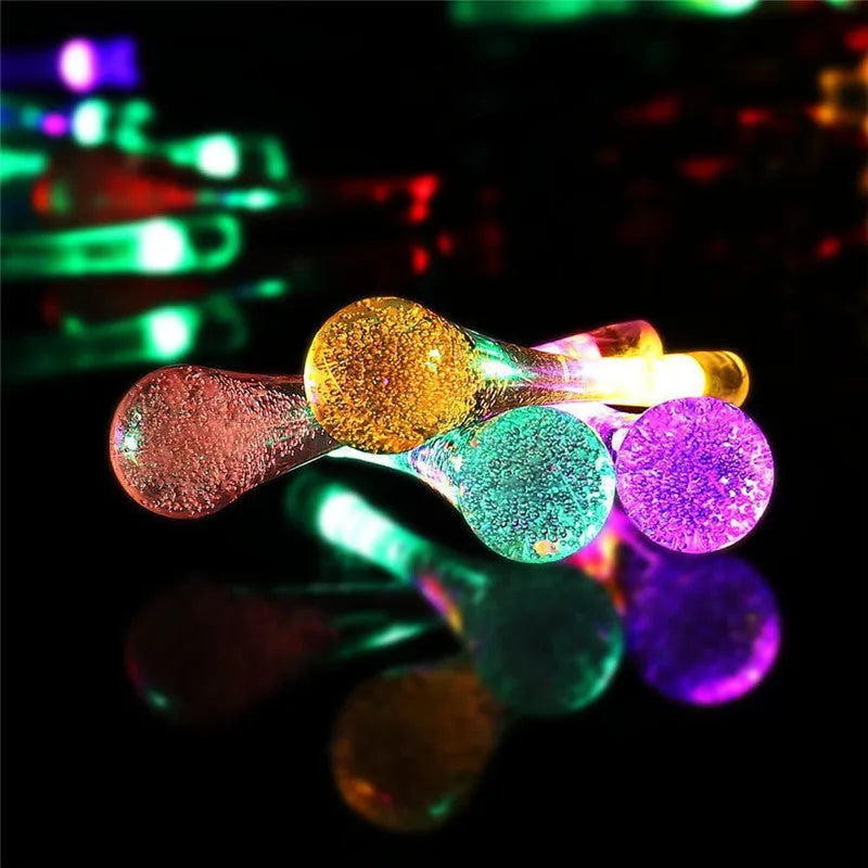 Solar-powered outdoor LED string lights with bubble drop pendants on a 6.5 metre cable.