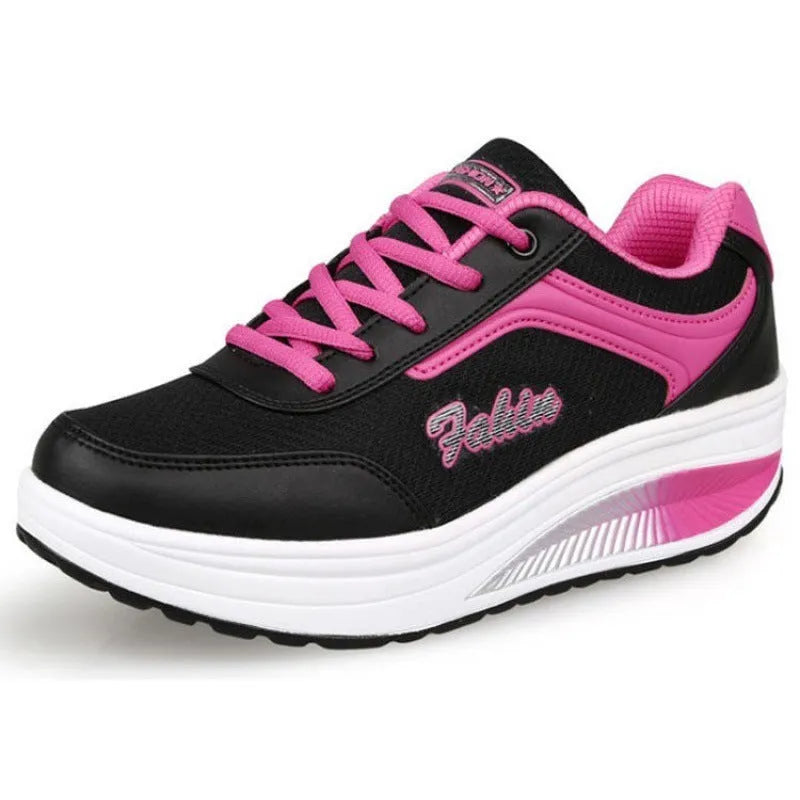 Women's grey powder heelless sports shoe with a mid-heel, shown on a neutral background.