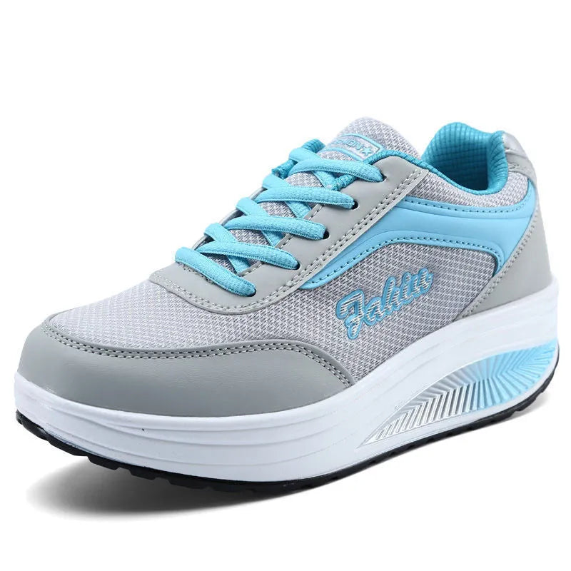 Women's grey powder heelless sports shoe with a mid-heel, shown on a neutral background.