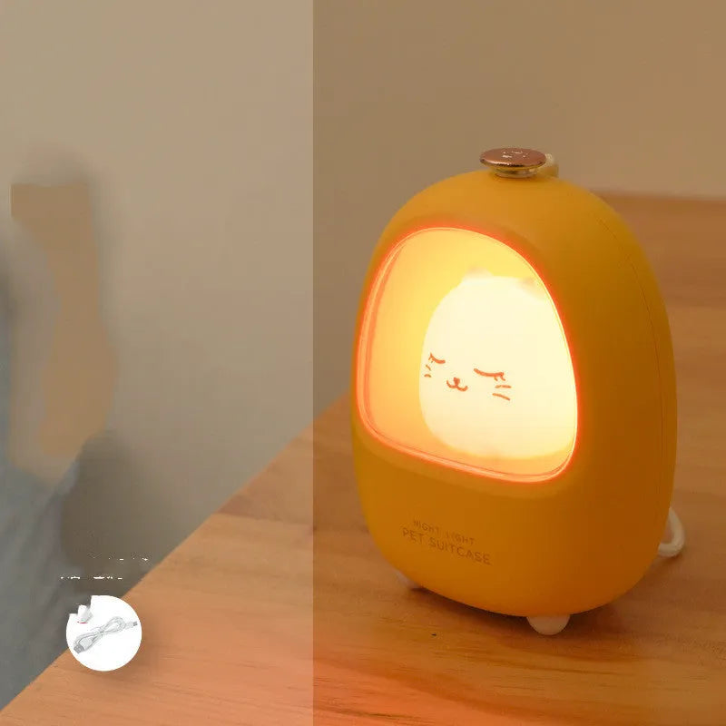 Portable cartoon-designed bedside night light with touch dimming control on a table.
