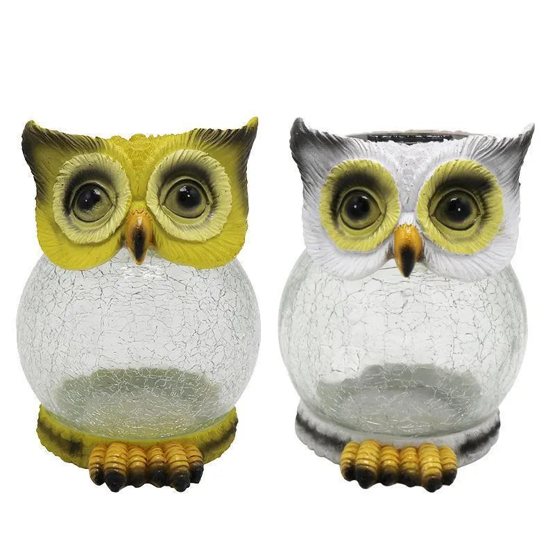 White and yellow LED solar-powered owl statue light for outdoor garden decoration.