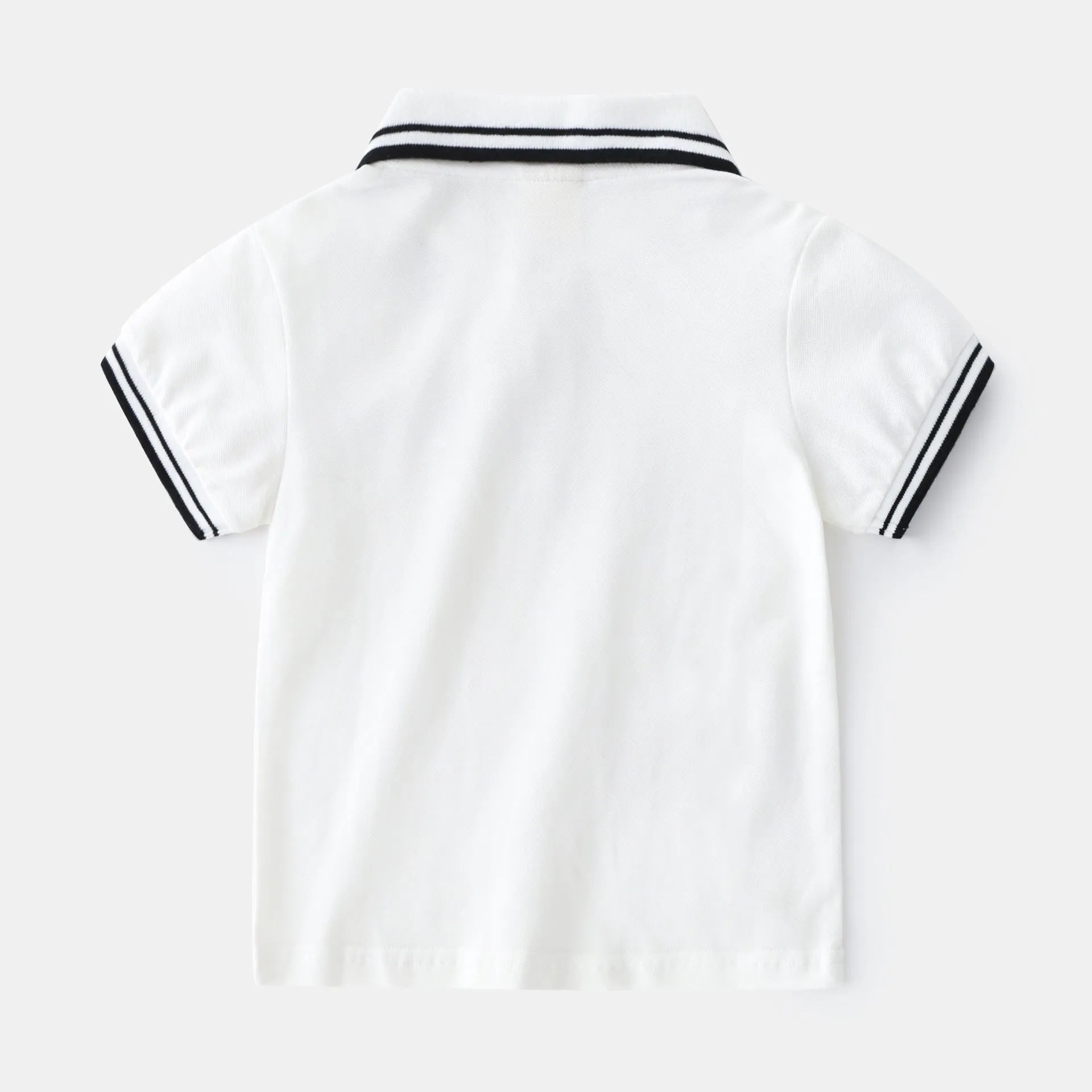 Boys' white and black short sleeve cotton polo t-shirt shown flat, suitable for summer.