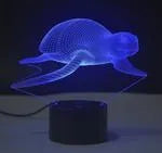 3D LED table lamp with acrylic panel on black ABS base showing multi-colour gradient illumination.