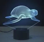 3D LED table lamp with acrylic panel on black ABS base showing multi-colour gradient illumination.