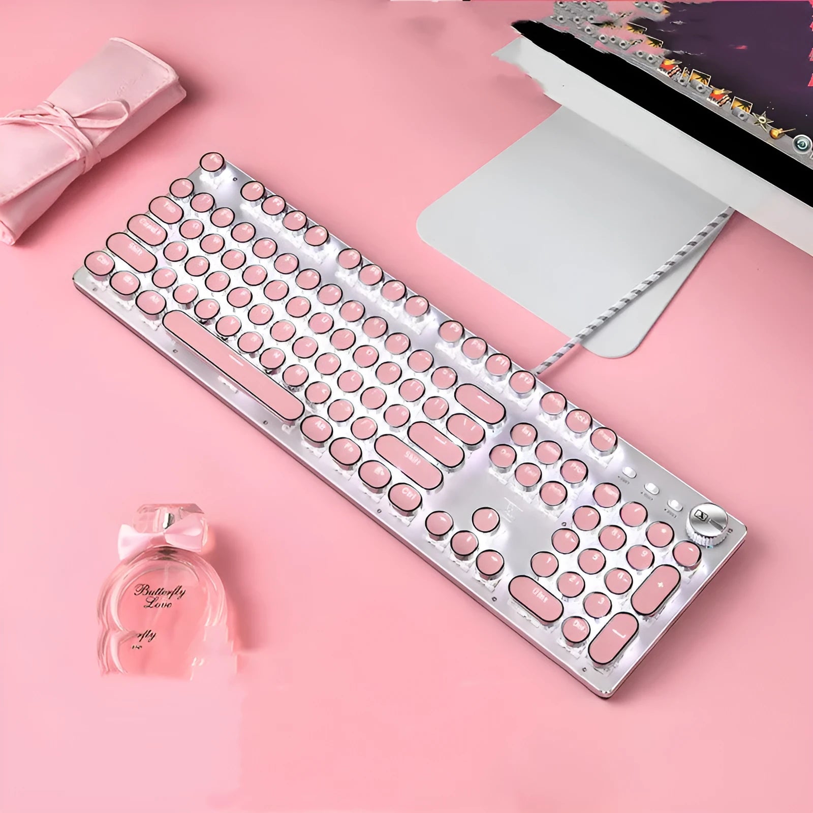 Queen Lipstick mechanical keyboard with silver base, pink keycaps, and green mechanical switches on a desk.