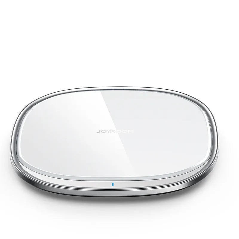 Black 15W wireless charging pad with zinc alloy rim and glass top on a wooden desk