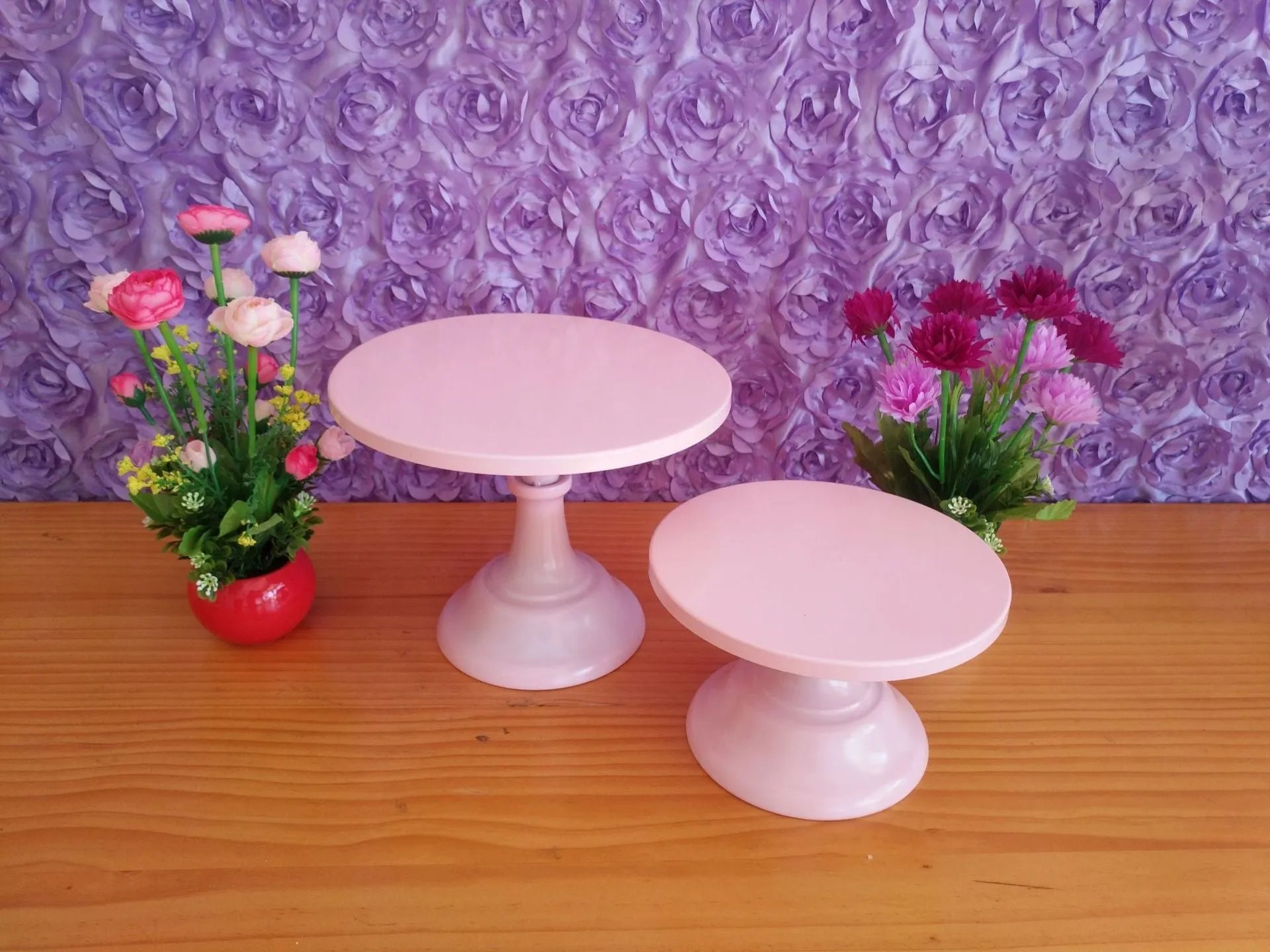 Three-tier metal dessert stand with 25cm trays in gold finish displaying cupcakes and pastries.
