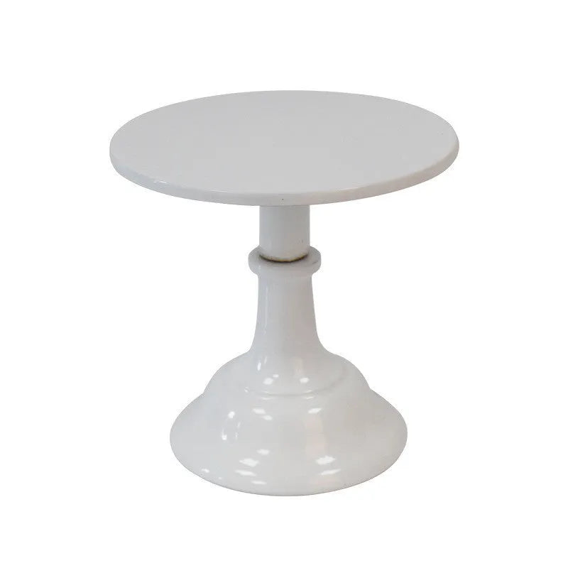 Three-tier metal dessert tray with 25cm plates in gold colour on a table with cupcakes.