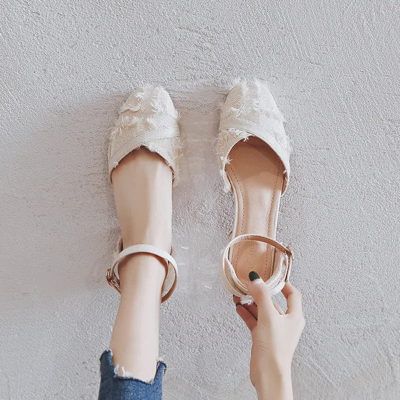 Women's apricot suede ankle-strap Dorsay flats with a 3cm low heel on a wooden surface.