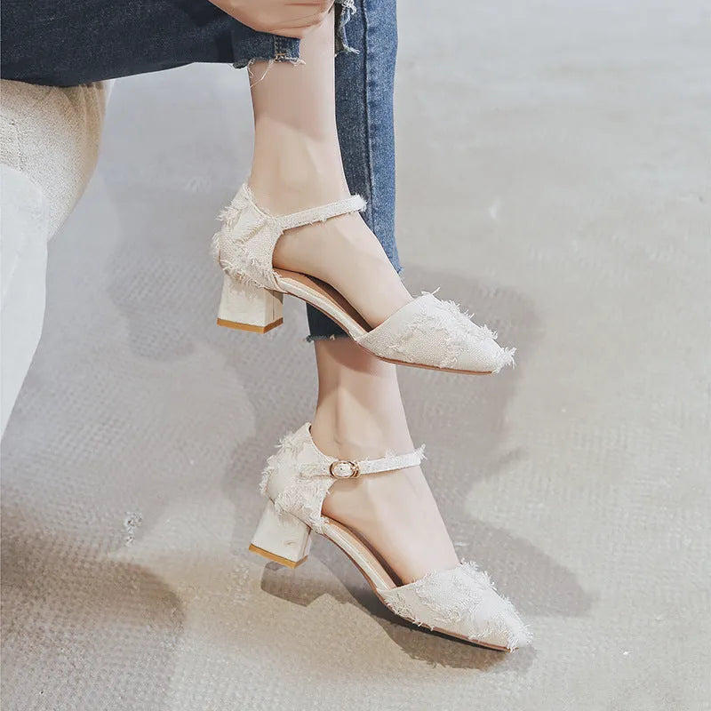 Women's apricot suede ankle-strap Dorsay flats with a 3cm low heel on a wooden surface.