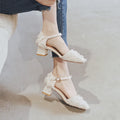 Women's apricot suede ankle-strap Dorsay flats with a 3cm low heel on a wooden surface.