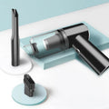 Wireless handheld car vacuum cleaner in black or white on a car seat.