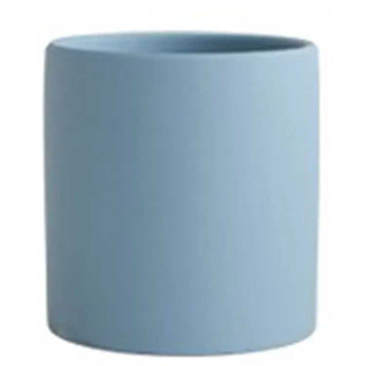 Cylindrical ceramic succulent planter with drainage hole in Nordic style, shown in a selected colour.