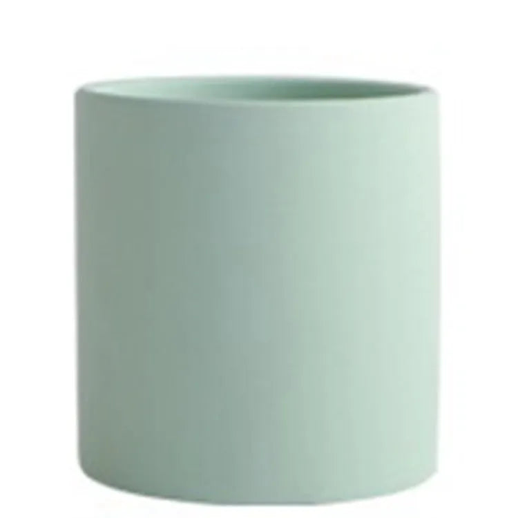 Cylindrical ceramic succulent planter with drainage hole in Nordic style, shown in a selected colour.