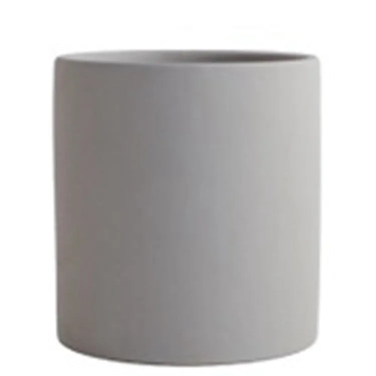 Cylindrical ceramic succulent planter with drainage hole in Nordic style, shown in a selected colour.