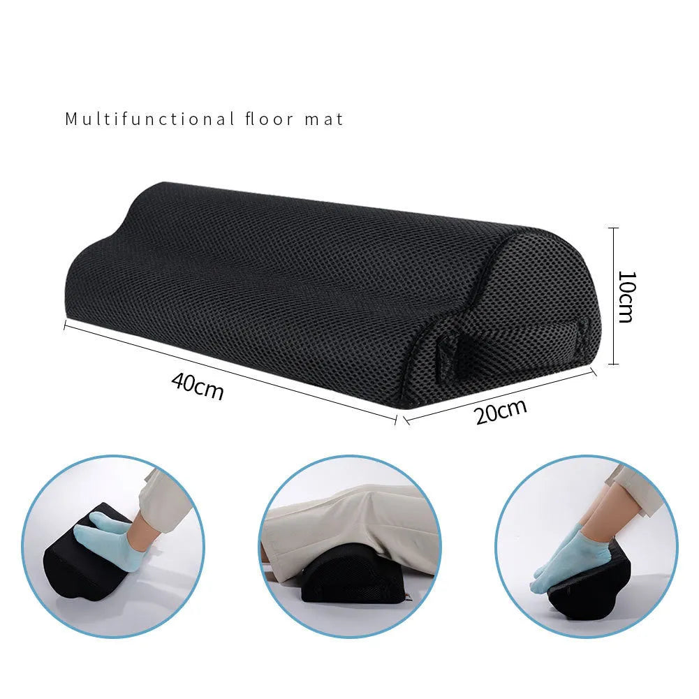 Semi-circular black foot rest pillow 40x20x10cm on floor under desk