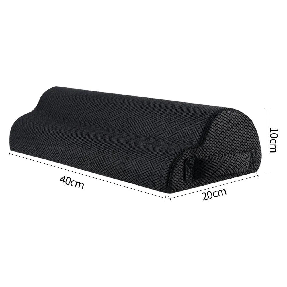 Semi-circular black foot rest pillow 40x20x10cm on floor under desk