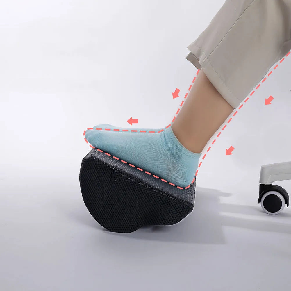 Semi-circular black foot rest pillow 40x20x10cm on floor under desk