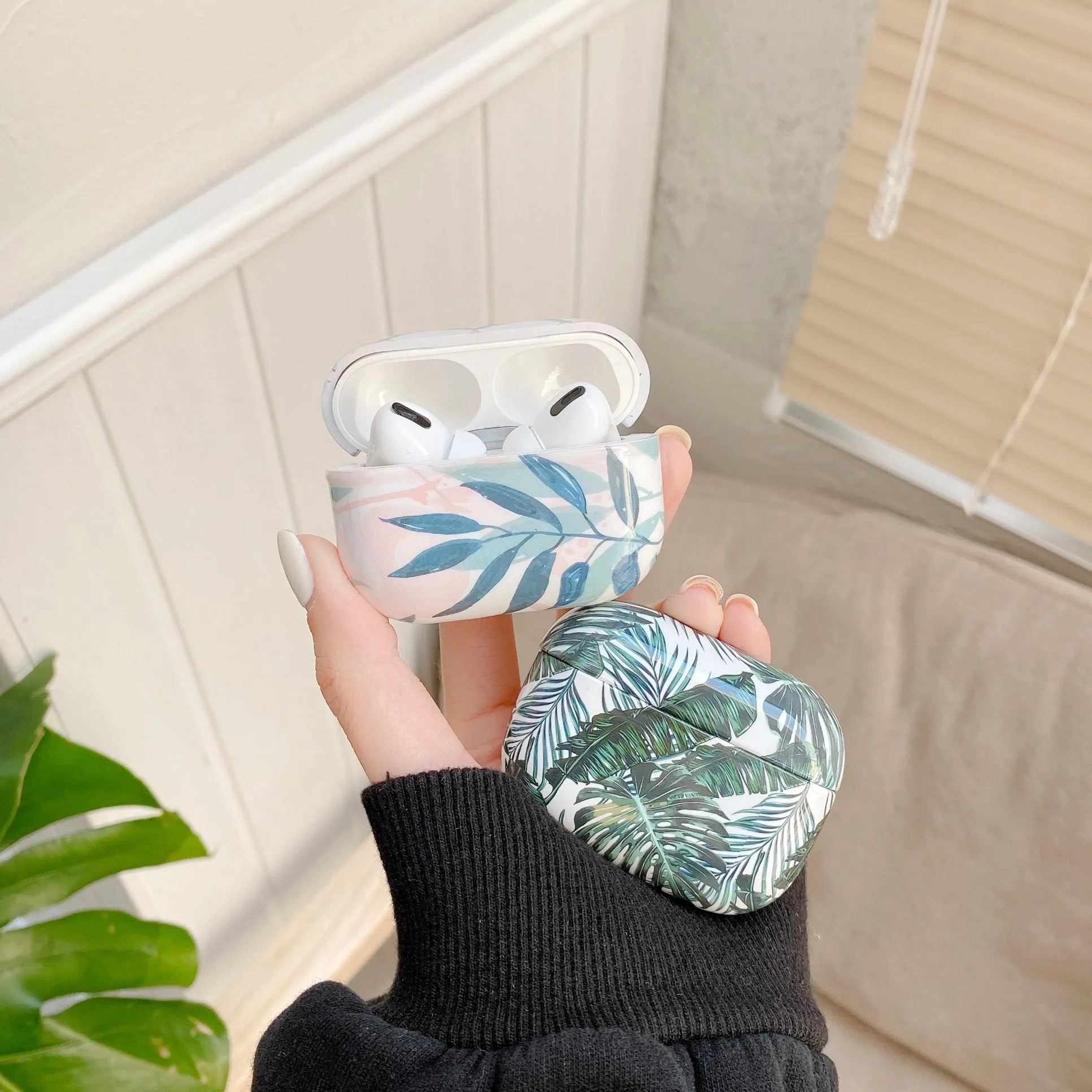 Blue and green banana leaf tropical pattern TPU silicone case for Apple AirPods.