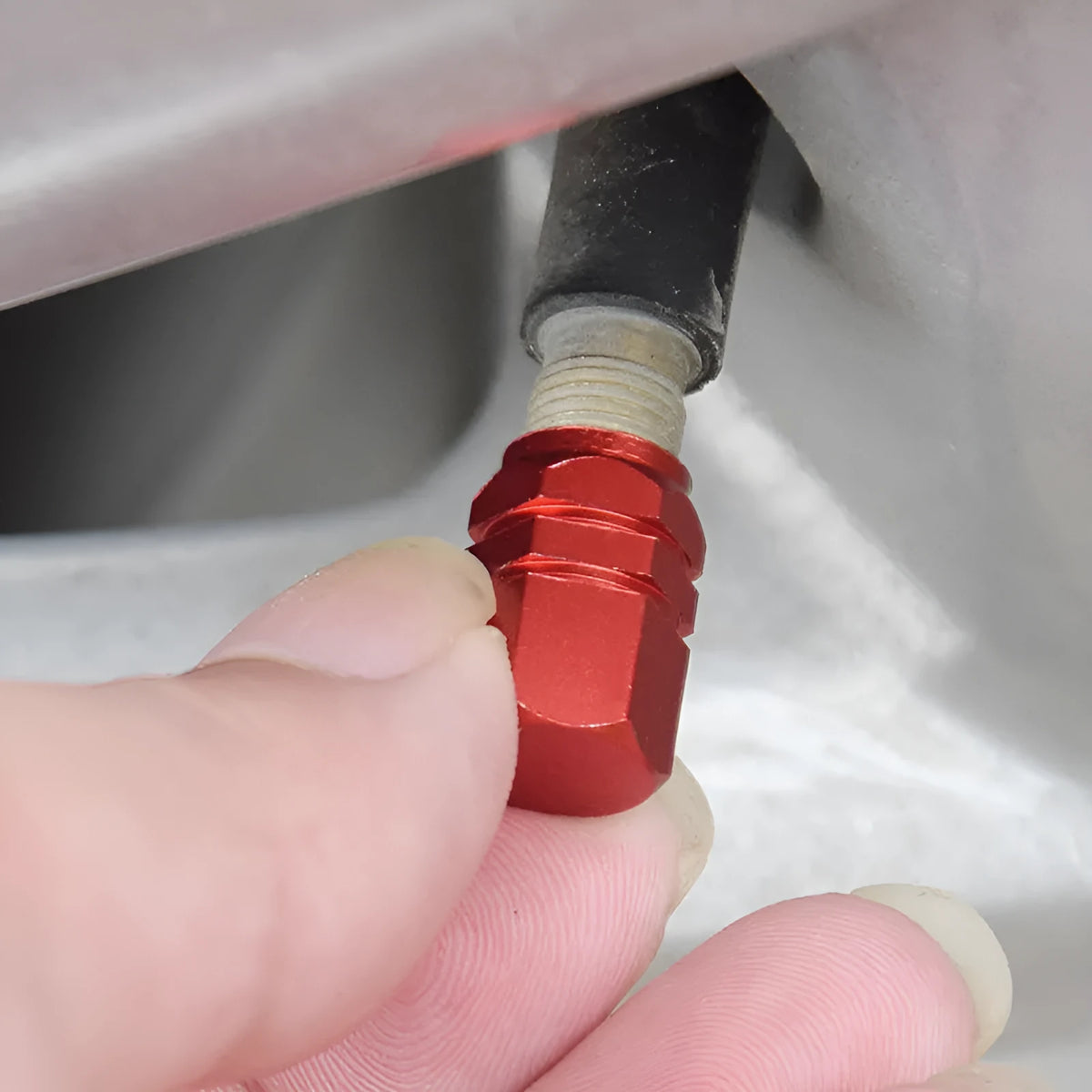 Set of five aluminium alloy car valve caps in black, blue, gold, red, and silver, designed for tyre valve stems with screw-on threading.