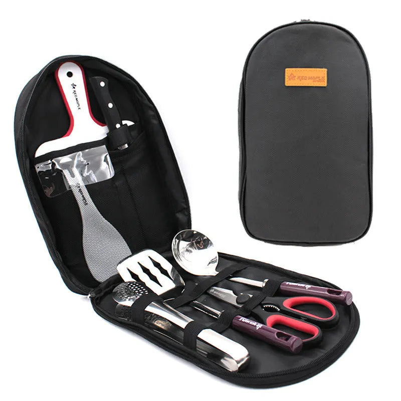 8-piece stainless steel camp kitchen utensil set in black storage bag on outdoor table